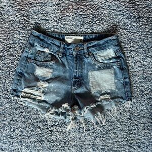 Distressed patchwork festival shorts